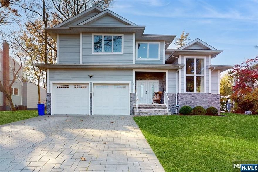 Welcome to 51 Roosevelt - a seven year young gem on a desirable cul-de-sac in the heart of Cresskill. Entering the side hall colonial with double height ceilings, you will be met with an open plan concept first floor. The large chef's kitchen opens to the spacious family room with gas fireplace and features extra details such as the coffered ceiling. Bright light pours in from the windows and sliding glass doors to the backyard with a stunning pergola. The family room leads to a formal dining area which in turn opens to a room which can be used as an office or den with pocket doors for extra privacy. A powder room and mudroom complete the first floor. The second floor is comprised of a Zen like primary suite with two walk-in closets, two bedrooms which share a jack and Jill, a mini suite and laundry room. The basement houses the 5th bedroom and 4th bathroom, as well as 2 rec room areas. This spacious, airy and bright home is totally move in ready and not to be missed.