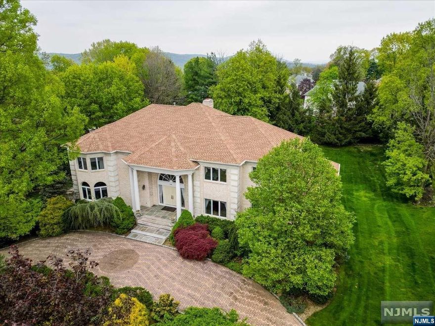 Colonial in prestigious High Ridge Estates combines luxury living w/ detailed craftsmanship. Grand 2 story foyer, you are greeted by an elegant marble FL & custom moldings. Spectacular great RM, features cathedral coffered ceilings & a 2-sided ceiling-to-floor fireplace. This central gathering spot is illuminated by natural light streaming through a floor-to-ceiling transom window. Adjacent to the great RM, the formal living & dining RM boast a sophisticated ambiance, w/ the dining area accented by a trey ceiling w/ subtle lighting. Office accessible via glass French doors, features arched windows. Eat-in kitchen has center island, granite counters & pantry. It provides easy access to the Trex deck via sliding doors, perfect for alfresco dining & entertaining. 1st FL also hosts a BR suite w/ walk-in closet & full bath. Ascending to the 2nd FL, 4 BR suites. Master suite is a true retreat, featuring 3 walk-in closets, dual vanities, jetted tub & shower. LL extends the living space.