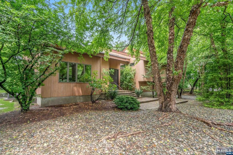 Wow! You must see this unique 4 bedroom, 3-1/2 bath, 4800+ sq.ft. home. This was custom designed by the owners and has high-end features galore. The huge master bedroom is on its own floor, has very high ceilings, and is highlighted by a handmade spiral staircase to a spectacular loft. The master bath has a sauna, jacuzzi, large shower, and tons of closet space. The bedroom floor has radiant heat. 3 bedrooms (1 ensuite),and a second bath are on the top floor of the home. The Poggenpohl Eat-in kitchen features Subzero, Bosch, Viking, and Miele. This level of the home features Crossville porcelain floors. The open floor plan is highlighted by a true open wood-burning fire place between the kitchen and living areas. A wonderful sunroom brightens the kitchen area, which also has a separate entrance/mudroom. The unfinished basement is tremendous with high ceilings, and multiple rooms. The 3-car heated garage has a fully separate work area. Specimen trees & plants highlight the outside.