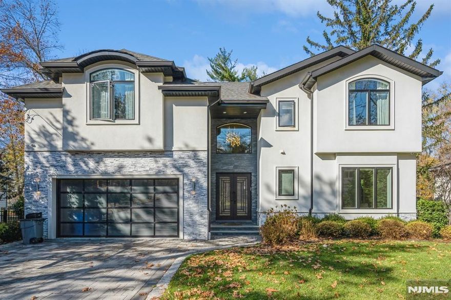 Nestled on the east side of Tenafly, this stunning 6,000 sq. ft. modern home offers a perfect blend of luxury and convenience. With an open floor plan, high ceilings, and white oak floors, the home is filled with natural light and a warm, inviting atmosphere. The sleek modern kitchen flows seamlessly into the family room with a cozy fireplace, making it perfect for gatherings. The primary suite is a serene retreat, featuring a spa-like bath and spacious walk-in closet. The lower level boasts exceptional amenities, including a home theater, gym, and infrared sauna. Outside, a beautifully landscaped yard with a sparkling pool provides the ultimate space for relaxation and entertainment. Conveniently located near buses to New York City, Tenaflyâ€™s top-rated schools, and houses of worship, this home sits on a flat .4-acre lot with a two-car garage, offering modern living at its best in a prime location.