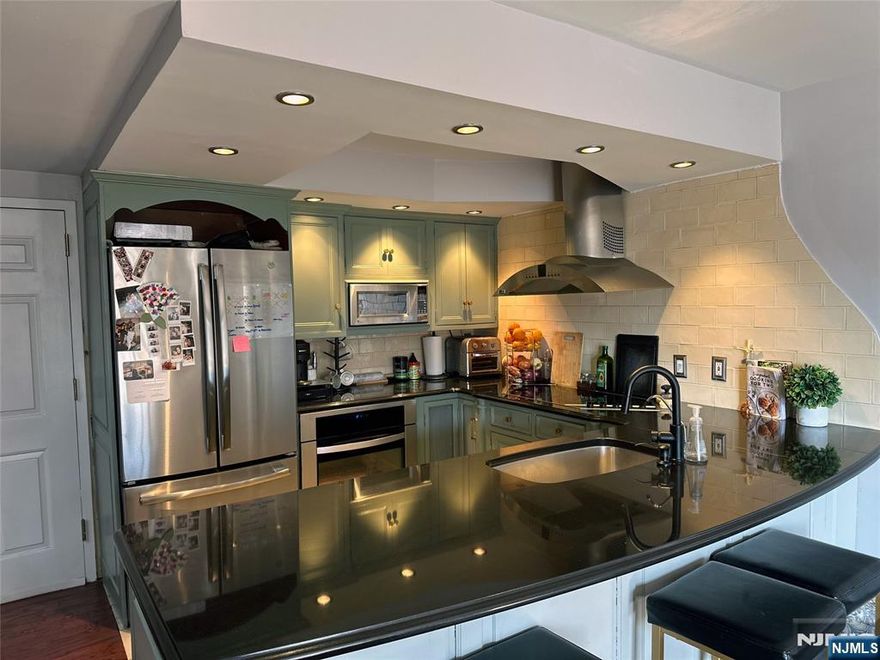 Commuter's Dream! Experience ultimate convenience in this sun soaked and cozy 2-bedroom, 1.5-bath corner unit condo. Perfectly situated for the modern lifestyle, this unit features a modern kitchen with sleek stainless steel appliances and plenty of cabinet space. Step out onto your massive private balcony, ideal for fresh air and relaxation. The primary bedroom and living area feature brand-new PTAC climate control units. Plus, the second bedroom will have brand new carpeting installed prior to your move-in date. Laundry room is right next door and will be getting new machines this year along with a new modernized elevator for the building. Parking is a breeze with a rare 1-car garage plus an additional assigned outdoor space. Unbeatable location for NYC commuters: literally a 1-minute walk to the train station and steps away from multiple bus linesâ€”also, to major highways. Enjoy the best of suburban-urban living with downtown shopping, dining, and local amenities just a short stroll away. Schedule your showing today!