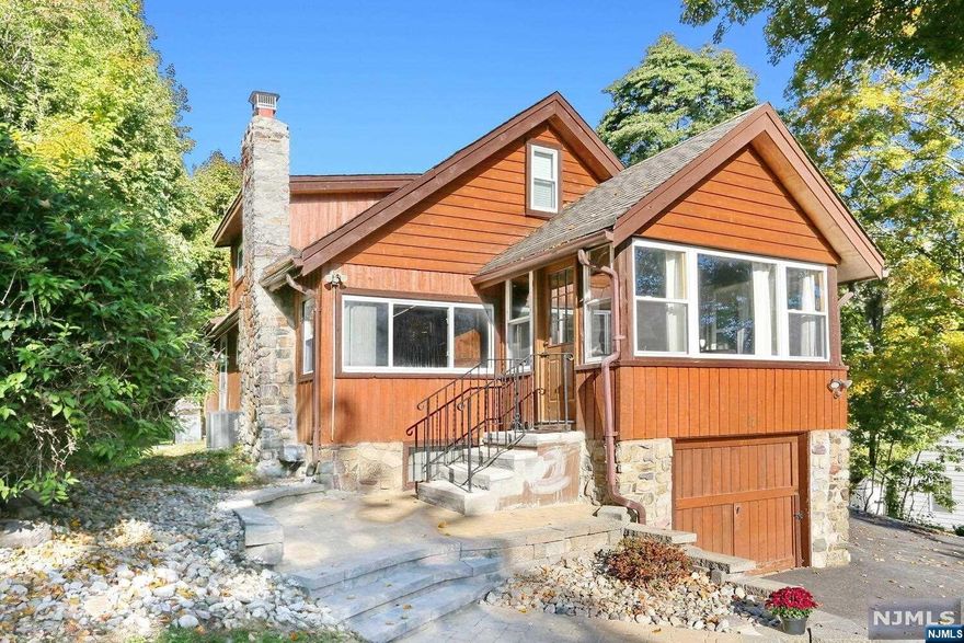 Indulge in the ultimate relaxation at this inviting log cabin boasting beautiful LAKE VIEWS! The sunroom, a sanctuary of natural light, welcomes you into this home & is the perfect place to enjoy the views or snuggle up with a good book. Immerse yourself in the harmonious blend of modern luxuries amidst a rustic atmosphere. Revel in the rare gem of a state-of-the-art kitchen, featuring high-end Miele appliances, custom cabinetry, & granite countertops. The cabin ambiance is enhanced by beautiful new Belgian wood flooring. Unwind in the spacious living room, complete with a cozy stone fireplace for those chilly nights. A 1st floor bedroom & a beautiful, serene marble bathroom add to the allure. The spacious sleeping loft accentuates the cabin's charm & is roomy enough for a crowd. Stepping outside you can enjoy a spacious yard with lake views & a shed with electricity for endless possibilities. Whether for lakeside living or a peaceful retreat, this cabin is your perfect haven!