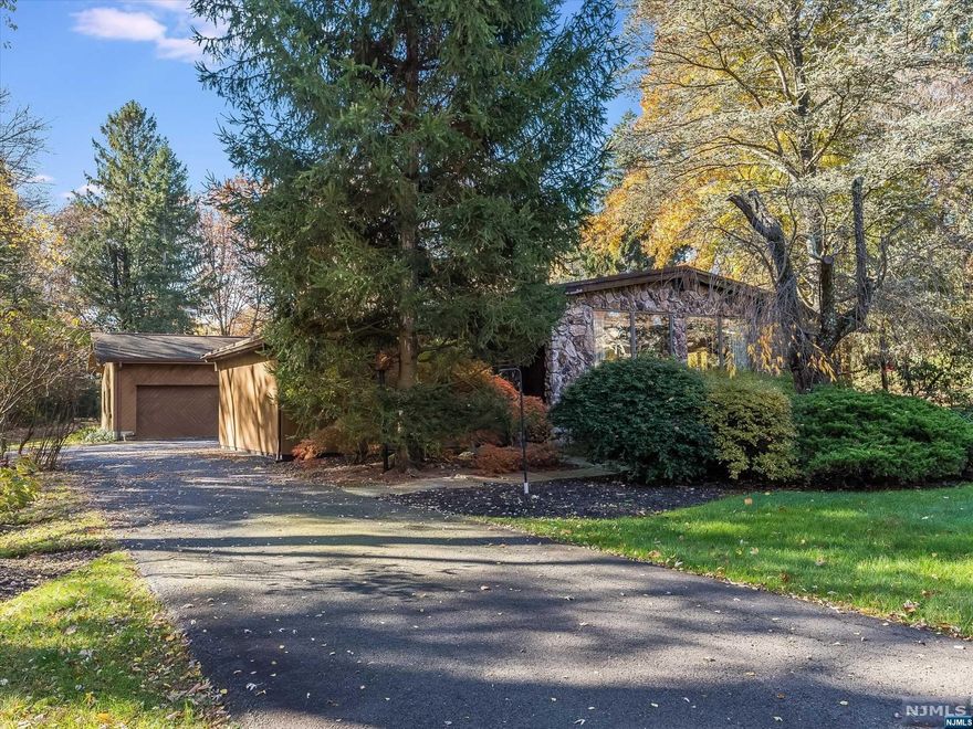 Custom Saddle River Elegance! Sprawling Ranch showcasing love of home and pride of ownership delivering all of the quality and comforts of one floor living to the most discerning buyer. Set on 2.2 PRIVATE parklike acres with welcoming entry and sprawling lush lawns, the possibilities are endless. Showcasing 3100+ sq.ft. of open entertaining living space plus addt'l 2000+ sq.ft. partially finished lower lvl and SPECTACULAR private park-like grounds with inground pool and wraparound deck. A one-of-a-kind estate! Vaulted & beamed ceilings, skylights, newer custom windows and doors, sundrenched living spaces to include living room, dining room, grand great room, eat-in Kitchen, fabulous primary suite w/sliders to private deck, expanse of windows, vaulted ceilings, primary bath w/dressing room, WIC.3 addt'l bedrooms, one ensuite plus full hall & lndry Rm. Expansive lower level ready for your custom finishes. A RARE Opportunity and spectacular find in highly sought-after Saddle River.