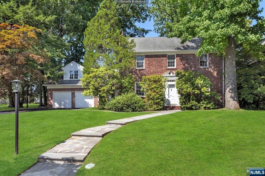 Classic, elegant and spacious brick center hall colonial situated on 90 by 125 property on premiere Teaneck street. Lovely entry hall, formal living room w/fp, formal dining room (butler pantry), double appliance eat in kitchen w/ large island, loads of cabinets & gorgeous breakfast area. Magnificent family room w/ beautiful built ins, floor to ceiling windows and french doors overlooks private backyard w/ relaxing portico. Powder room, mudroom, and oversized 2 car garage complete first floor. Second floor has five very spacious bedrooms... 2 primary bedroom suites, 3 additional bedrooms, an office and 3.5 baths. Finished basement w/bedroom, play area, full bath & laundry. Other features include second back staircase, hardwood floors, beautiful wainscoting & moldings, 2 zone heat and air, ug sprinklers, flagstone patio, tremendous closet space throughout and enormous storage attic. Close to all.