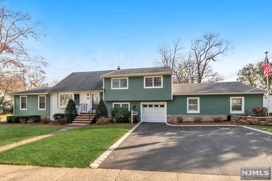 Welcome to this beautiful, expanded split-level home with an attached garage & an open-floor layout perfect for entertaining & comfortable living! The gourmet kitchen features a breakfast bar, granite countertops, custom cabinets, tiled backsplash & floor & stainless steel appliances including a five-burner Bosch stove top with range hood. The breakfast room flows seamlessly to the open-plan dining room & family room area with vaulted ceiling & a wood-burning stove. Sliding doors from the breakfast room open up to a covered, paver-stoned patio looking onto the completely fenced back yard. Wow friends with the patio's pizza oven, brick grill & fire pit. Indulge in the indoor, heated 16 x 36 in-ground pool off the ground-level family room with full bath. The second floor consists of two bedrooms plus a bonus room which could work as a third bedroom & a luxurious bath; the third floor is bright & light, boasting a good-sized bedroom with a full bath.