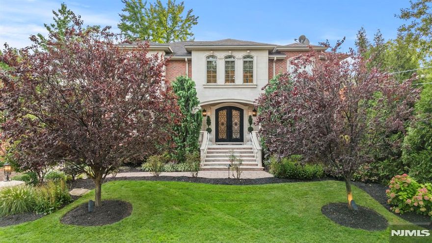 Welcome to this exquisite brick & precast, 2011 custom colonial nestled in highly desirable Englewood Cliffs. Perfectly blending classic elegance with modern amenities, this luxury home features a private elevator to all 3 levels with over 8000 SF of living space. Enter through the double doors & be immediately impressed by the grand foyer with iron staircase, designer porcelain tiles with radiant heat, handsome built-ins & intricately stenciled walls. Gourmet chef's kitchen with butler's pantry opens to an expansive paver patio with fully-equipped outdoor kitchen & lush landscaping with waterfall, providing the perfect backyard oasis. 6 spacious bedrooms with ample storage, 4.5 luxurious baths, 2-car heated garage & extended paver driveway, plus a finished, walk-out lower-level with summer kitchen make this home ideal for extended families. Too many features to list, this special home is for the most discerning buyer to enjoy proximity to NYC, low taxes & the best of Bergen County.