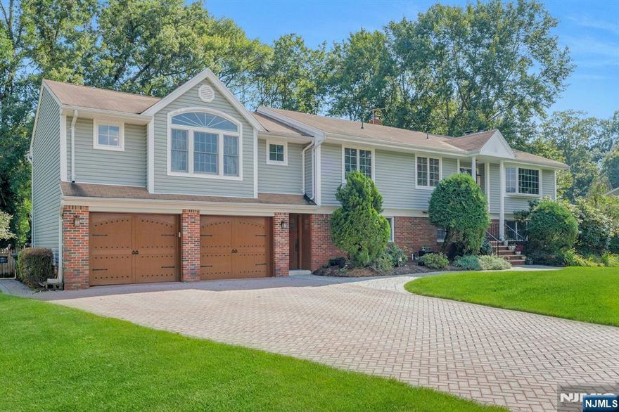 Welcome to this exceptional custom home, cherished by just two families since 1973. Designed for everyday comfort and memorable gatherings, this unique mother/daughter layout offers two private entrances, two full kitchens, and flexible space across two levels. The main floor features four bedrooms and three full baths. The primary suite is a retreat with cathedral ceilings, dual walk-ins, a private deck overlooking the pool, and a spa-like bath with marble finishes, radiant heated floors, Jacuzzi tub, and walk-in shower. The chefâ€™s kitchen boasts Sub-Zero and Garland appliances, granite counters, custom Plato cabinetry, butcher block, skylight, and slate-look tile. Just steps away, the dining roomâ€”with cathedral ceiling, beams, stained-glass windows, French doors, and skylightsâ€”opens to a welcoming living room w/stone fireplace and bay window. The ground level includes two bedrooms, a full bath, a cozy family room with fireplace and sliding doors to the backyard, plus a second kitchen and brand-new luxury vinyl flooringâ€”perfect for extended family, guests, or entertaining. Details like custom pine doors, radiant heat serving 3 bathrooms on the 1st floor, three wood-burning fireplaces, a wood stove, and dual laundry stations add warmth and character. Outdoors 20x40 heated pool. Newer equipment and paver patios. Fenced yard, sprinkler system, expansive deck, and a private outdoor shower. A rare find offering timeless craftsmanship. Pride of ownership!