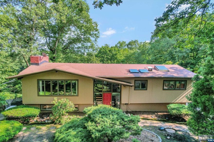 This exquisite property showcases 8 rooms, with 3 bedrooms including a master bedroom featuring a sliding glass door to the deck, 2.5 baths, and a modern kitchen complete with granite countertops. The home captivates with cathedral ceilings in the large living room, boasting a cozy fireplace and double sliding glass doors that open onto a x large spacious deck overlooking the meticulously landscaped one-acre lot. Access to the in-ground swimming pool makes this residence perfect for entertaining. Nestled in a very private backyard, this haven of relaxation is meticulously maintained, reflecting a clear pride of ownership. Positioned on a serene cul-de-sac, the property is within walking distance of the award-winning Kinnelon Schools ,close to essential shopping and NYC transportation. Outdoor enthusiasts will delight in the nearby hiking trails and the County park with its sports fields, picnic areas, and seasonal views of the Butler reservoir sold in as - is condition. !!!.