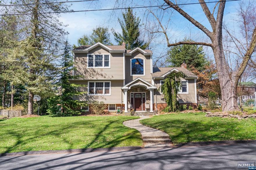 Welcome to your dream home in Harrington Park! This updated gem offers modern luxury and convenience. Enjoy bright and open living spaces with hardwood floors, tons of natural light, and vaulted ceilings. The kitchen boasts quartz counters, a large island, and stainless steel appliances. The great room, featuring vaulted ceilings with exposed wood beams and access to a spacious deck, is an ideal spot for relaxation and entertainment. The primary suite on the top level features a luxurious bathroom, while a junior suite on the main level and a fully finished lower level provide ample space. Home's layout could work well for extended family. Recent updates include a new boiler and water heaters for added comfort. This home seamlessly combines style and practicality. Located on a quiet dead-end street, close to the town pool, and within a coveted school district, this residence epitomizes Northern Valley living at its finest.