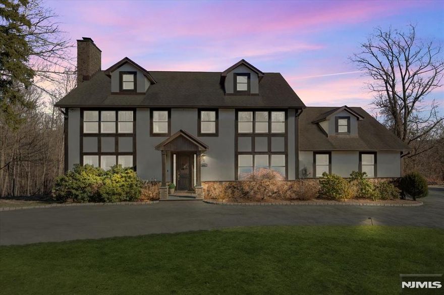 When a builder merges two lots and designs his own custom home, the result is a masterpiece of thoughtful design and craftsmanship. This stunning residence offers an expansive layout, blending luxury, functionality, and timeless elegance. Step inside through the tiled entry foyer, leading into an oversized living room with a striking stone wood-burning fireplace, perfect for cozy gatherings. The eat-in kitchen is a chef's dream, featuring custom cabinetry, walnut flooring, granite countertops, and stainless steel appliances. A perfectly sized dining room, powder room, home office, and laundry room with an additional half bath complete the first floor. Upstairs, the master suite is a true retreat, boasting a steam shower, walk-in closet, and an additional bonus room, offering endless possibilities for expansion into a dream closet, nursery, or private sitting area. The three additional bedrooms are generously sized and share a massive guest bathroom, featuring heated floors, a whirlpool tub, and luxurious marble finishes. The phenomenal finished basement provides even more living space, highlighted by a second wood-burning fireplace and sliding doors leading to a blue stone patio, creating the perfect indoor-outdoor flow. Designed for both comfort and convenience, this home includes a heated three-car garage and a circular driveway for effortless access and added curb appeal. Recent upgrades include a new natural gas furnace, 75-gallon water heater, and a five-burner gas cookt