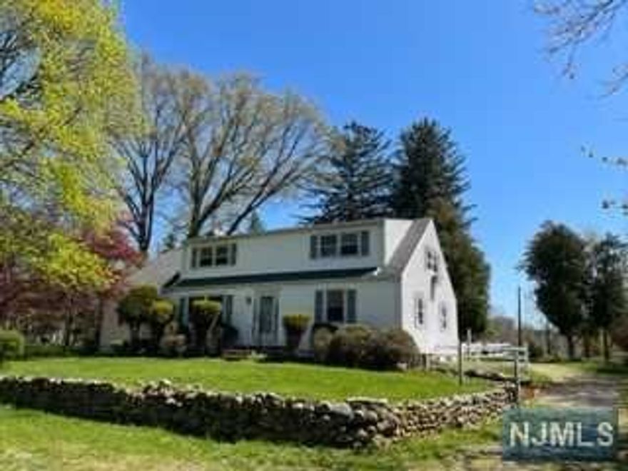 Attention all builders & DIYers! Bring your ideas to bring out the best in this 1930s Cape Cod Colonial. Set high on a hill on over 1.6AC in the middle of town, the sunsets are spectacular & opportunities like this are rare! Take the long driveway to a reach a totally private setting in the heart of Ramsey. Upon entry, you'll find a spacious kitchen, large family room, living room w/wood-burning f/p & "secret passage" to the dining room, plus 2 bedrooms & full bath. Upstairs are 2 more generously sized bedrooms w/their own full bath. There is also a separate room for storage. A one car garage & full unfinished basement w/new (2018) furnace complete the home. An oasis in the heart of Ramsey, this location is special. Home is being sold "as is".