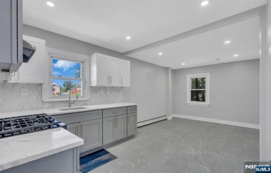 EXCEPTIONAL 2-FAMILY HOME IN NEWARK! This beautifully upgraded multi-family residence is ideal for both investors and owner-occupants seeking a move-in-ready, income-generating property in a vibrant and accessible Newark neighborhood. Unit 1 spans two levels, occupying the first floor and finished basement. The main level offers two well-sized bedrooms one featuring charming bay windows and a fully renovated bathroom. The modern kitchen boasts quartz countertops, updated appliances, a spacious dining area, and direct access to the backyard. The lower level includes two additional bedroom areas, a second full bathroom, and another access point to the backyard. Unit 2 has its own entrance leading to the second floor. This unit includes a bedroom area with bay windows, plus two more generously sized bedrooms. A nicely renovated full bathroom and an updated kitchen with dining area and backyard access complete the layout. Additional highlights include elegant moldings, updated flooring, modern plumbing, and thoughtful design touches throughout. Both units feature front and rear entrances, enhancing convenience and privacy. Located just steps from public transportation and within blocks of parks, schools, shops, and restaurants. Whether you're looking to live in one unit and rent the other, or add a high-quality property to your investment portfolio, this is an opportunity not to be missed. SCHEDULE YOUR PRIVATE TOUR TODAY!