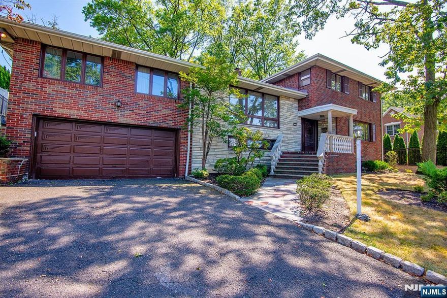 Boasting over 4,000 square feet of living space, this spacious and meticulously maintained home is sure to impress. From the gracious entry hall, youâ€™ll access an elegant living room, formal dining room, family room, den, office or potential bedroom, and a sunlit eat-in kitchen. The kitchen and dining room open onto a two-story slate terraceâ€”perfect for entertaining. A separate wing on the main floor features its own living area, summer kitchen, full bathroom, and bedroomâ€”ideal for multigenerational living or private guest accommodations. Upstairs, the primary suite offers a walk-in closet and two additional bedrooms and a full bathroom. The ground level features a second family room with a wet bar, powder room, laundry area and access to the oversized garage. Additional features include a four-zone gas/hot water heating system and two zone central air.. Conveniently located just a short walk to Upper School, NYC buses, and upscale dining. A rare opportunity to move to this highly sought-after community with low taxes and just minutes from New York City.