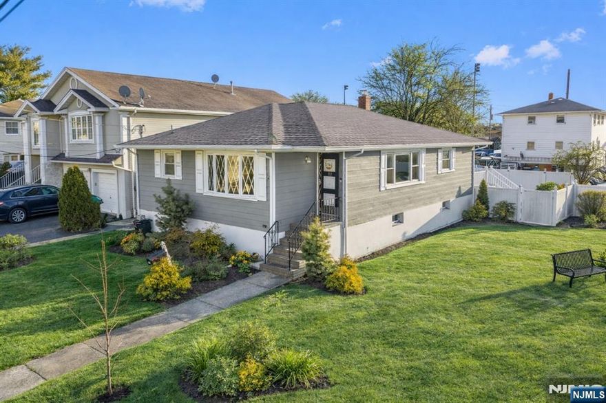 Beautifully renovated in 2022, this move in ready home in Lodi offers a refined, modern aesthetic with every major upgrade already completed. The immaculate kitchen features sleek quartz countertops, stainless steel appliances, recessed lighting, and a breakfast bar area perfect for barstool seating, flowing seamlessly into a sun filled living room and a spacious dining area with ample room for a full sized dining table, ideal for entertaining. Generously sized bedrooms include a primary suite that easily fits a king sized bed, while the fully renovated basement with LVP flooring provides additional living space, washer and dryer, a large utility room, and abundant storage. Major updates include a newer furnace and central air system under two years old, a new roof, and a newly paved driveway. Enjoy a large private deck and backyard with no neighbor on the right side for added privacy, all in a prime location with quick access to New York City, offering an elegant, luxury feel without the need for any renovations.