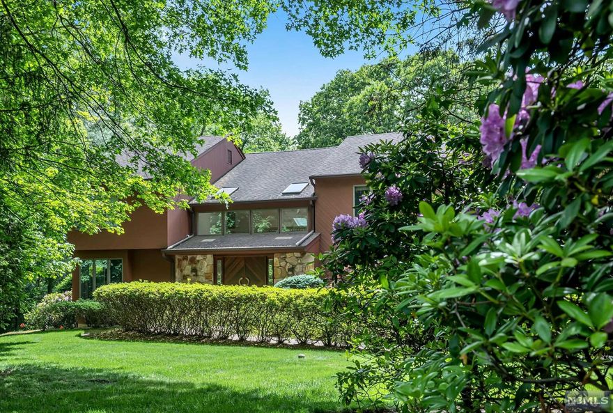 Nestled on one of the more desirable cul de sac streets in Demarest, this meticulously maintained cedar contemporary home on Country Club Way exudes peace & tranquility. The mature landscape surrounds the home & offers ultimate privacy. With many windows & skylights galore, the home is full of light & happiness. The main floor features a spacious floor plan with a formal living room, great room/FP, kitchen, dining, powder room & a bedroom/full bath. The primary bedroom/bath plus 3 bedrooms, a full bath and a study nook finish the 2d floor. The walk-out basement is outstanding for entertaining and offers a recreation room with an amazing sports bar, steam sauna/shower/bath, oversized gym plus a game room unlike anything you have ever seen! Gunite pool with hot tub. Generator included. A definite MUST SEE! Don't miss this opportunity to own a rare gem in Demarest. NOTE: taxes were reassessed & lowered by $11k. WELCOME HOME!