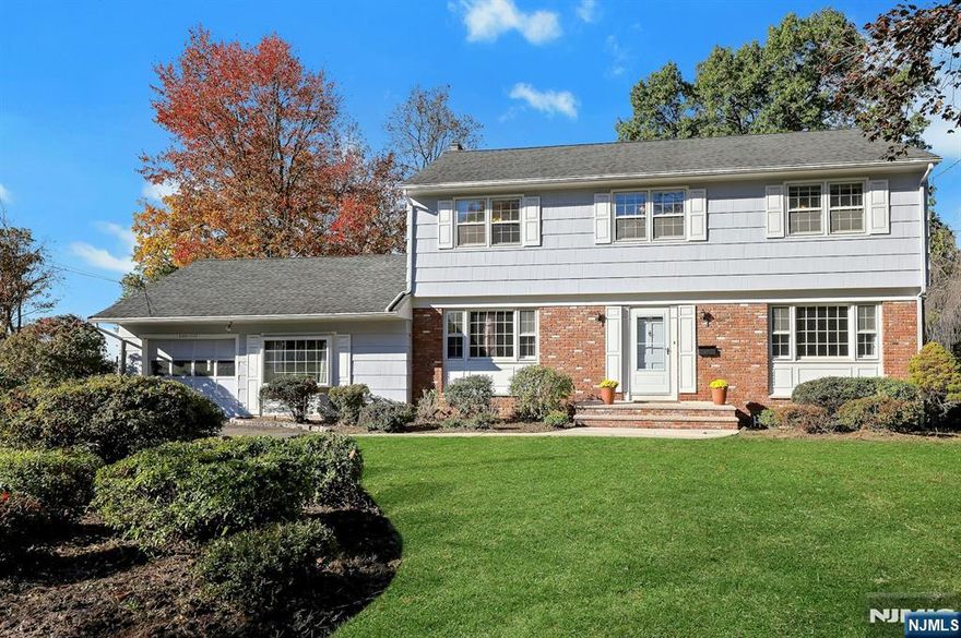 Welcome to Packanack Lake Living! Discover this beautifully maintained Colonial situated on nearly a half-acre of level, manicured property in one of Wayne's most desirable neighborhoods. This home offers over 2,400 square feet of living space, plus an additional 1,014 square feet in the unfished walk-out basement, providing endless potential for recreation or storage. The inviting living room features updated recessed lighting, crown molding, and large sun filled windows. The formal dining room is perfect for gatherings and the enjoying two-sided fireplace, shared with the family room. The family room features a bar and sliders to the expanded deck. The eat in kitchen offers stainless steel appliances and a convenient side door leading to the exterior. A bonus room on the main level can easily serve as a den, home office, or lounge. Gleaming hardwood floors throughout the whole home. Upstairs, the serene primary suite boasts crown molding and an en-suite bath, complemented by three additional bedrooms and a full main bath. Outside, enjoy a large, level, park-like backyard, perfect for play, entertaining, or peaceful outdoor living. The home also includes an attached one-car garage for added convenience. Experience top rated schools and the best of Packanack Lake living; a perfect blend of comfort, community, and convenience in one of the areaâ€™s most sought-after neighborhoods.