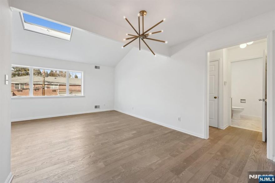 This beautifully renovated modern apartment is a must-see! Bright & spacious, it is flooded with light thanks to multiple skylights. The chef's kitchen boasts brand new stainless steel luxury appliances & stunning quartz countertops. The open living & dining rooms feature numerous windows, ensuring a bright and airy feel. The apartment is adorned with brand new modern hardwood floors throughout. The bedroom offers large windows & a spacious walk-in closet, while the full bathroom is beautifully designed with a soaking tub & another skylight. Central air ensures comfort year-round. Included with the unit is one car parking in a private building lot, with plenty of additional parking for guests. Laundry facilities are available in the basement for tenants. The secure building is located in an amazing location in the heart of Park Ridge, near everything you need. On-site is a renowned salon and dry cleaners. Don't miss this opportunity to live in an amazing boutique-style unit!