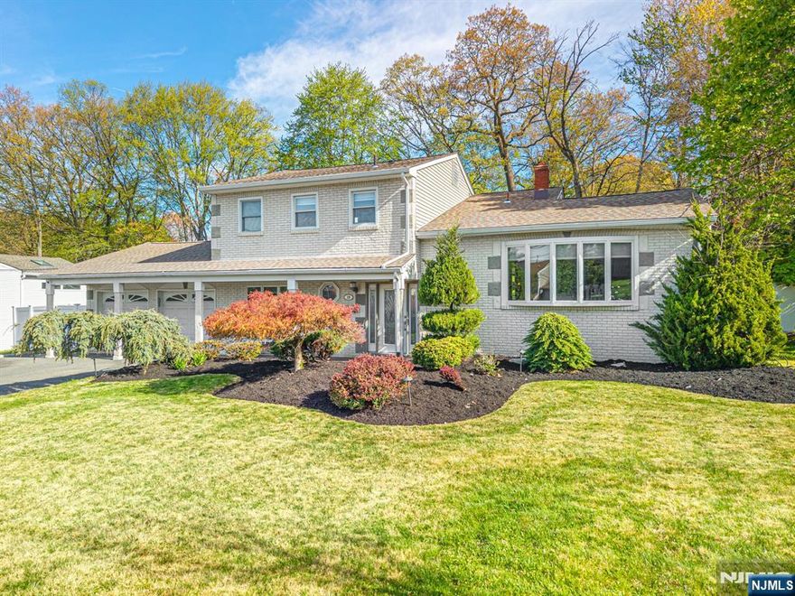 An entertainer's dream! With impressive curb appeal and a thoughtfully designed interior, this home blends elegance and functionality with a WOW factor inside and out. Offering 4 levels of living space, it features beautiful windows and custom moldings throughout. Step into the welcoming foyer and enjoy ground-level conveniences including a powder room, bedroom, office/den/playroom (or possible 5th bedroom), spectacular great room, gourmet kitchen with sliders to the backyard, and a spacious formal dining room. The eat-in kitchen boasts stainless steel appliances, a one-of-a-kind custom center island with seating, and high-end finishes, perfect for everyday living and entertaining. First floor, just steps from the ground level, is a sun-drenched, spacious living room with dry bar. Upstairs, the primary suite offers an en-suite bathroom with double vanity, step-in shower, & walk-in closet. Two additional bedrooms share a full bathroom. The backyard is a true retreat, featuring a two-level paver patio, heated in-ground pool with slide, cabana with fridge & storage cabinets, built-in fire pit & storage shed, ideal for summer gatherings. Additional highlights include a whole-house gas generator, hardwood floors, granite counters, recessed lighting, newer roof (3 years young), and a 2-car garage w/outside access and expansive driveway to accommodate 5 cars. Conveniently located near schools, shopping, houses of worship, major highways, & NJ Transit, this one checks all the boxes.