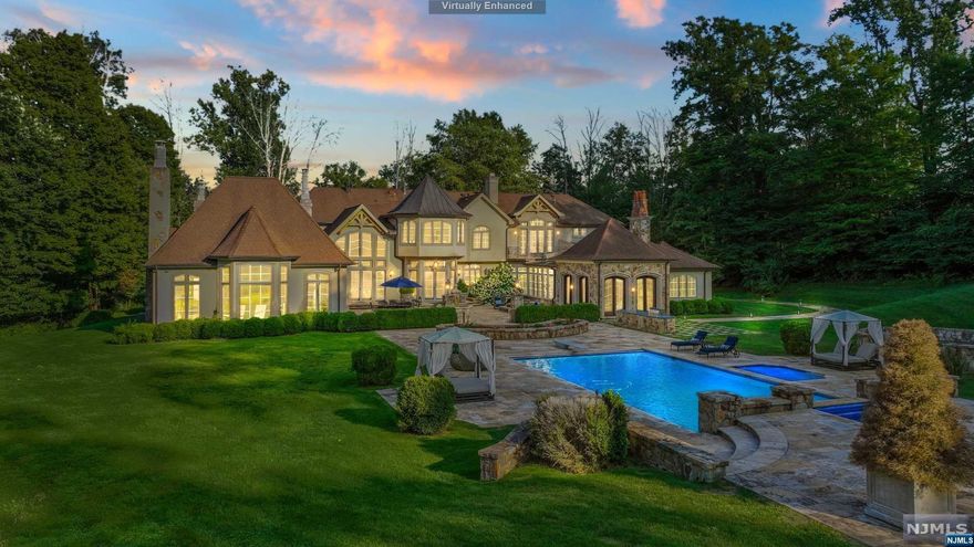 Welcome to a custom-built estate in coveted Mendham Township. This 5-bed, 5-full bath, 1-half bath residence sits on 5+ lush acres. Enter the grand foyer, greeted by natural light in the inviting living room. The heart of this home is the custom chef's kitchen, adjacent to a spacious dining room. The great room features a meticulously restored 18th-century French fireplace, flowing into the pool area for entertainment. Explore the left wing with an intimate loggia, stone fireplace, bespoke theater, gym, and private office. Upstairs, five en-suite bedrooms await, including a luxurious primary suite with a fireplace, spa-like bathroom, and sitting room. The private primary suite patio overlooks the landscaped backyard. Outside, the heated pool has hand-carved Neptune heads from France, a spa, and a fire pit for tranquil evenings. The partially finished basement offers storage or customization. Your dream estate awaits!