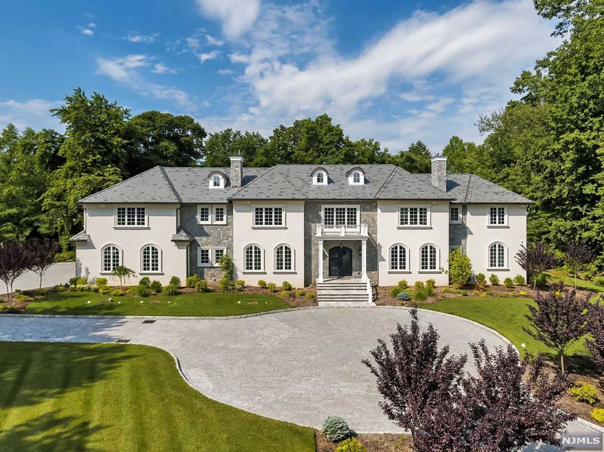 2016 grand modern classic estate by one of the area's premier builders, was chosen for 2016 Designer Showhouse For Heroes to Heroes. (Photos from the Showhouse). Magnificent residence set on 2+ flat acres, at the end of a prime Chestnut Ridge double cul-de-sac, this stone and stucco home has it all! Real slate roof, state of the art Kuche-Cucina kitchen and cabinetry throughout the house, 6 bedrooms, including 2 primary bedroom suites (one on the 1st floor) all with ensuite bathrooms and walk-in closets. A smart home,radiant and hydronic heating combination, 4 car garage, generator and elevator. A beautiful B&B salt water heated pool and a cabana, surrounded by professionally designed landscape. 9,000+ sq.ft. plus a full height, unfinished basement. Plans for a finished basement are available. Owner has NJRE license.