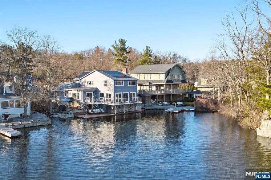 Beautifully Renovated Lakefront Located On Upper Greenwood Lake. Panoramic Water View. Open Floorplan And High Ceilings. Large Kitchen Island With High End Finishes. Stunning Wood Floors Throughout. Wood Burning Fireplace. Primary Bedroom Features Ensuite Bathroom with Double Vanity, Rainfall Shower and Soaking Tub. Tons of Closet Space. Additional Rooms include Office and Oversized Game Room. Outdoor Features Trex Decking, Paver Patio and Wood Fired Pizza Oven. Entertainers Dream! Located Near Restaurants, Apple Orchards, Wineries & Drive-In Theatre.