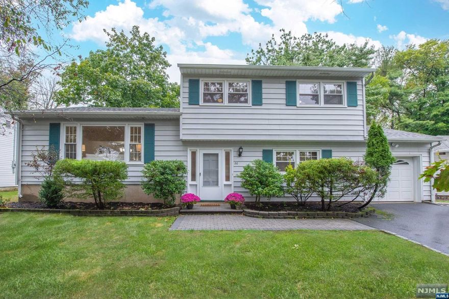 MOVE RIGHT INTO this 4 bedrm, 2 bath home w/a recently renovated kitchen & bath! The interior was just freshly painted in neutral colors & with gleaming h/w flrs... just unpack your bags & enjoy the quiet, cul de sac location! The winning floor plan begins on the ground level, where you will find a convenient bedrm & full bath plus an inviting fam/rm w/ built ins. A mudrm accesses the paver patio & flat yard. The 1st flr showcases the new eat-in kitchen which features custom cabinets w/ crown molding & quartz counters, ss apps. The liv rm overlooks the foyer on one side and adjoins the din/rm on the other. A three season sunrm completes this level. The 2nd level includes the primary bedrm plus 2 addl bedrms & a new bath w/quartz counters.The basement w/high ceilings is easily finishable. C/A & amazing storage throughout! The attached garage is accessible from the ground level. Short walk to NYC trans, 2 parks, Applegate Farms. Enjoy everything that Upper Montclair has to offer!