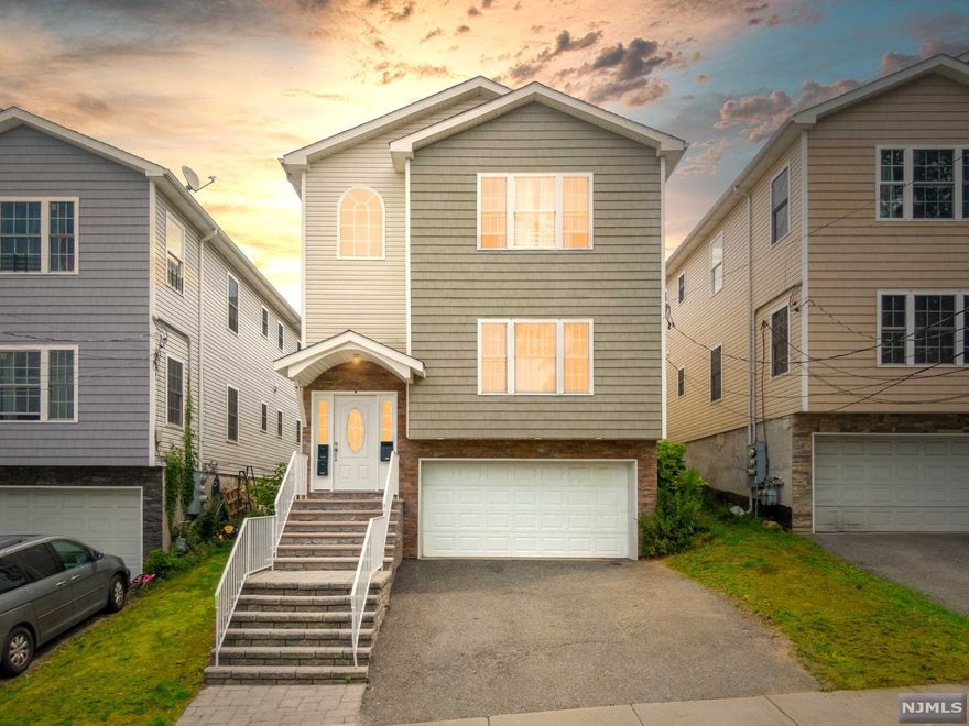 Come see this beautiful Two-Family with exceptional community amenities. The home includes two separate 3 Bedroom apartments, over a ground floor 2 car garage. The renovated garage features a full bath, kitchenette, laundry room and storage. Both apartments are identical, offering enjoyable living/dining spaces, two full baths and stainless steel appliances. All bedrooms are generously sized, with each primary bedroom containing two walk-in closets and a full bath. The property sits on a quiet street, parting it from others in the area. The community allows for easy commute to Manhattan while giving residents the opportunity to enjoy the outdoors within the Garret Mountain Reservation, right down the street!