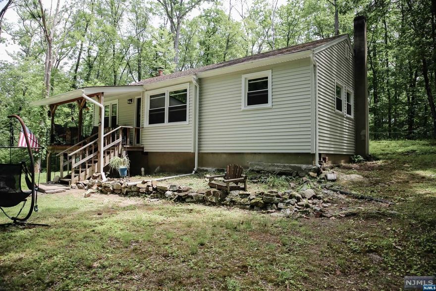 Home sweet home you will be in this ranch nestled in the woods. If you're looking for privacy, this is the home for you. Home has two bedrooms plus another room that can be used as a bedroom/office or den. Living room, kitchen and dining room all a good size. Step out from your dining room to a beautiful patio area. Nice size laundry room with sink. The windows were replaced in 2015, Brand new septic system 2017, hot water heater and furnace replaced approx 2017. New stove. (Hardwood floors under laminate) Convenient location and easy access for commuting purposes. Move right in!