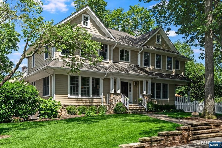 Stately architecture and superior craftsmanship define this custom-built 2011 colonial with Hardie Plank siding, Timberline roof, white oak floors with mahogany inlay, and elegant trim. A covered entry with paneled columns welcomes you into a sunlit foyer flanked by a banquet-sized dining room and formal living room. The heart of the home is the chefâ€™s kitchen featuring black granite counters, white custom cabinetry, island seating, desk area, Fisher Paykel range, twin pantries, and a bright eat-in area with bay windows overlooking a fenced yard with paver patio. The covered porch, ideal for indoor/outdoor entertaining, is accessed directly from the eat-in kitchen. The adjacent family room offers a gas fireplace. Upstairs, the luxurious primary suite boasts tray ceilings, two walk-in closets, and a spa-like bath with soaking tub, oversized shower, double vanities, and private water closet. Three more spacious bedrooms with tray ceilings and double closets share a full hall bath. A laundry room completes the second level. The finished lower level includes a rec room, half bath, storage, and access to an oversized 2-car garage. Professionally landscaped grounds feature retaining walls, paver walkways, and mature plantings. Approx. 3,050 SF. Additional highlights: reverse osmosis, sprinkler system, water softener, hard-wired security system, and central vac.