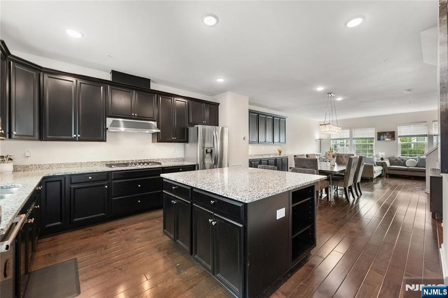 Call Charmy Morzaria at 609.619.2198 to tour: Welcome to the FINEST & sought after Colonial Style Luxury townhomes in North of NJ located at Wesmont Station Community of Wood Ridge. Just 30 mins from Manhattan, close to major turnpike and freeways, it offers ease of commute; wesmont train station just 5 mins walk away and option of two buses going into Manhattan that runs every 10-15 mins. This property offers an amazing size bedroom on the lower level, has 4 park space; 2 car garage and 2 car drive way. 1st floor offers beautiful open layout with modern updated kitchen, huge pantry and oversized island, it also has half bath, dining space for large gatherings, massive living area and a great sized outdoor deck. 3rd floor offers primary bedroom suite w/full bath, two walk-in closet(plus additional custom made closet system offering additional storage), two add'l bedrooms, full bath & laundry room. Wood-Ridge has top rated elementary school. A hassle-free community living at its best, it offers plenty of convenient options; coffee shop, liquor shop on the premises, two playground, jogging/walking area, dog park, leisure garden/green space from where you can witness beautiful sunset sky. Schedule your tour today!