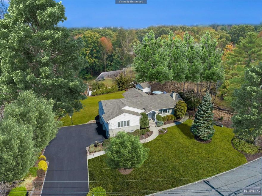 Classic elegance greets you upon entering this impeccably maintained 4 bedroom Ranch. Each room, spacious and bright, offers quality finishes that make this home truly special. The heart of the home is the tastefully designed chef's kitchen showcasing an oversized center island that overlooks the yard through beautiful wall to wall windows. Other special features are the vaulted ceiling, granite countertops and professional grade appliances which include a Viking Stovetop & oven, Subzero Fridge and Dacor exhaust. Enjoy indoor/outdoor entertaining through the French doors that lead out to the freshly painted deck featuring a Yamaha sound system. Just off the kitchen is the gracious dining room that also features French doors that lead outside. Enjoy the primary bedroom featuring an uber chic en-suite bath with charcoal black vanity, brushed gold accents and quartz countertop. The walk-in closet completes the primary bedroom.