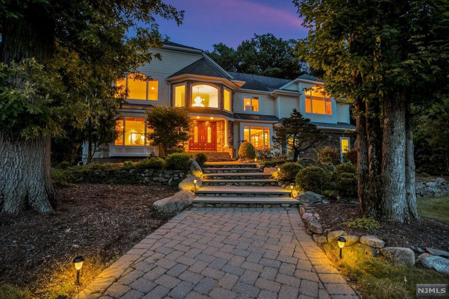 MUST SEE TO BELIEVE! Spectacular 6 BR,4.5 BA home, over 5,000 sq ft, .86 acres, in converted USR. What a rare find! Your own private oasis w/ waterfall pond, heated pool and pool cabana. Green space for kids to play. Beautifully framed by tall trees, this is an impressive home by any measure. Huge chef's high-end kit, w/ custom built-ins, seated island & more. High ceilings & banquet size DR. This home will WOW you w/ views from every room & lots of windows. Enjoy relaxing in your great room w/ heated floors and surround sound. Layout is perfect for everyday living & entertaining. 2nd Fl has 6 BR's, huge MBR & sitting area, Lux MBA w/ heated floors & WIC. W/D room & hardwood floors throughout. Finished basement offers a massive rec room/gym & workshop. No need to leave home! Top schools! Just 20 miles from Manhattan and the GWB. 3-car garage. Municipal sewer (NOT SEPTIC!!!)