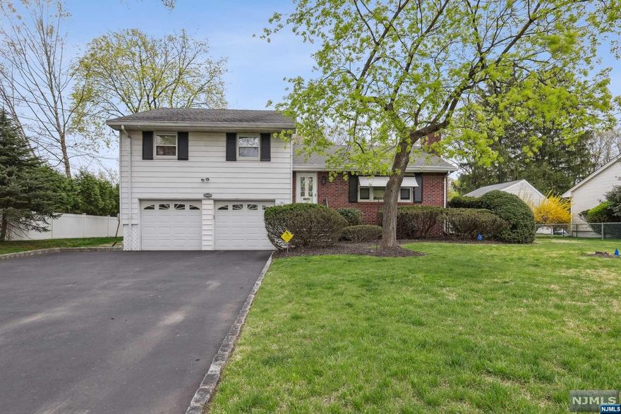 Welcome to 697 Prospect St, nestled in the heart of Glen Rock! This move-in ready split-level home offers a wealth of possibilities. As you step inside, natural light floods the space, creating a warm and welcoming atmosphere. The bright front living room leads seamlessly into the dining area, where you can continue to enjoy the home's open and airy layout. The extended living room is a true focal point, expanding the abundant natural light, hardwood floors, and direct access to the back deck. The kitchen completes the first level, providing functionality. Upstairs, the second level hosts three bedrooms and a full bath. The master suite boasts a spacious walk-in closet and an en suite bath with a standing shower. The lower level provides access to the two-car garage, the backyard, and the basement. This home is situated in a prime location with easy access to the commuter train as well. Come explore the possibilities of this charming home.