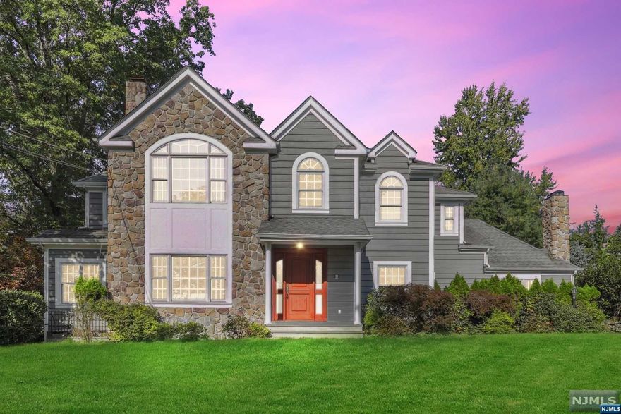 Welcome to this magnificent center hall colonial offering unparalleled luxury and comfort with 6 bedrooms and 5.2 baths. The spacious eat-in kitchen is a chef's delight, featuring rich wood cabinets, stunning granite counters, center island breakfast bar with a sink, stainless steel appliances, wet bar with fridge, butler's pantry and breakfast area. The main level also boasts an inviting living space with spacious rooms and hardwood floors throughout. The formal living room includes a wood fireplace with marble mantle and tray ceiling. Enjoy an elegant meal in the formal dining room featuring a tray ceiling and wainscoting. The bright den is very large and the family room includes a cathedral ceiling and stone surround fireplace. The 1st floor also includes a convenient guest bedroom with an ensuite bathroom. Upstairs, the primary bedroom is a true sanctuary, complete with two WIC's, fireplace,