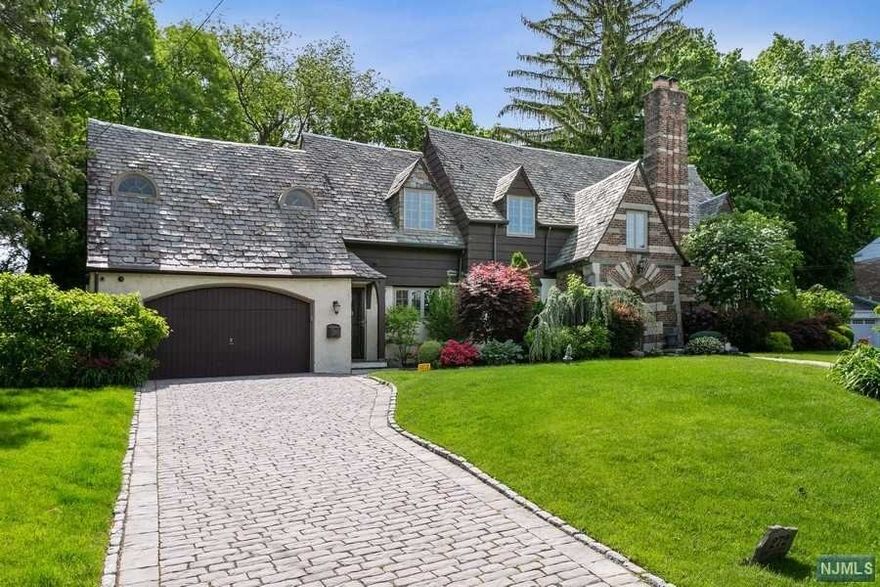 This is the one, the storybook house you have dreamed of can now become your reality! Located in the very desirable & quiet Maple Hill Section the past meets the present w/curb appeal to die for. This house has it all. A few of its features are: Approx. 3,000sq' of living area plus a finished basement sitting on a beautifully landscaped lot that is approx.10,000sq'. Fully updated kitchen w/granite counters & Breakfast Island, Large formal dining room, Huge living room w/gas fireplace, Billiard room, Stained glass windows, 3 zone central ac, Anderson windows, Gorgeous Hardwood floors, Master suite + an in-law/nanny suite at the other side of the house w/its own stairway. Fully finished basement w/den, bathroom & private spa including a walk in steam shower & dry sauna. The outdoor oasis includes a decked in Jacuzzi, a private outdoor sitting area w/cooling fan, outdoor kitchen, sprinkler system & outdoor lighting. Close to express bus to NYC, schools, shopping & Hackensack Hospital