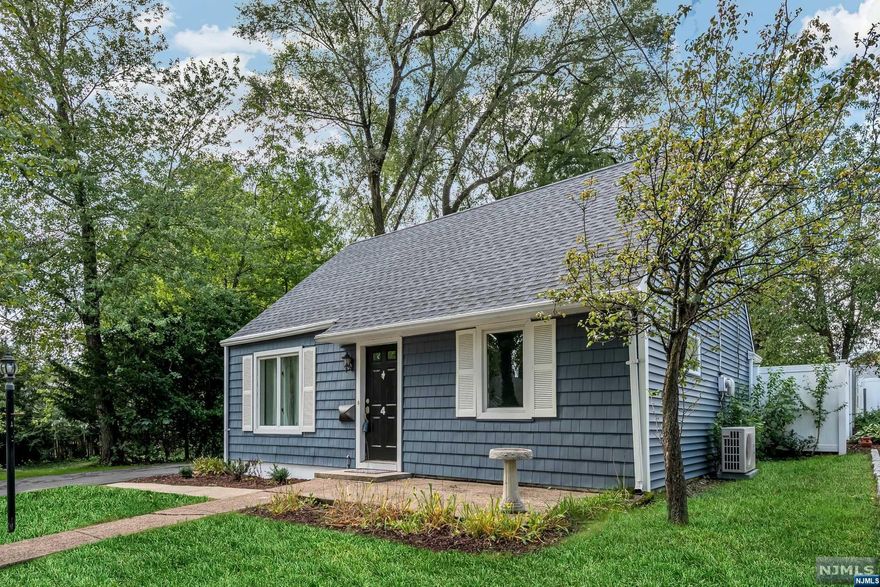 Don't miss this opportunity to own this tastefully renovated Cape Cod nestled at the end of a peaceful cul-de-sac. This home offers an open floor plan with sunlit kitchen featuring hickory cabinets and stainless steel appliances. The spacious first floor primary bedroom offers double closets. The living room, den, full bath and laundry area finish off the main floor with it's gleaming hard wood floors. Add to this two additional bedrooms on the second floor, a detached garage and fenced in yard and you've found your dream home. Additional upgrades in the past few years include: new vinyl siding, new roof on both house and garage, new garage door, vinyl fence, new kitchen, mini-splits, hot water heater and paved driveway. This home is conveniently located to NYC transportation and is adjacent to a charming park.