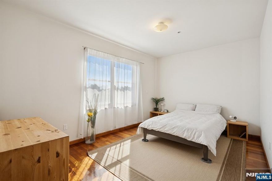 Welcome to this sun-drenched penthouse condo in the heart of Union City! This top-floor corner unit offers sweeping views of the Manhattan skyline through oversized windows, filling the space with natural light all day long. Enjoy the ease of modern living with a brand-new washer/dryer, dishwasher, and microwave. The open layout features hardwood floors throughout, creating a warm and inviting atmosphere. Perched in a prime location just minutes from Manhattan with low monthly maintenance and an included garage parking space, this home blends style, comfort, and convenience. Donâ€™t miss your chance to own this bright and beautifully updated city retreat!