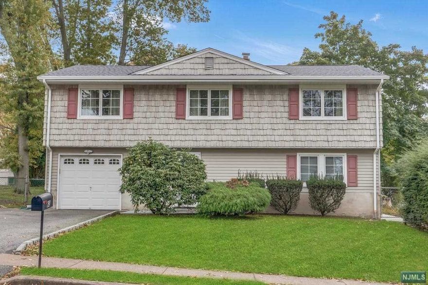 ABSOLUTELY STUNNING best describes this beautifully updated 4 bedroom, 3 bath raised ranch! Lovely first level entry foyer with French doors leading to spacious family room with bamboo floors and recessed lighting, summer kitchen with ceramic tiles, dinette and sliders to paver patio - perfect for entertaining. Bright bedroom and full bath complete first level. You'll be WOWED by the open concept second level with living room and dining area with hardwood floors. Gourmet kitchen features granite countertops, subway tile, stainless steel appliances, dinette area with vaulted ceiling and door to large deck. Master bedroom with full bath, two additional bedrooms and updated full bath complete the second level. Add'l features include new roof, 2 zone central ac, new patio, fenced in yard and much more! Close to schools, shopping and transportation. This home has it all and you'll love living here!