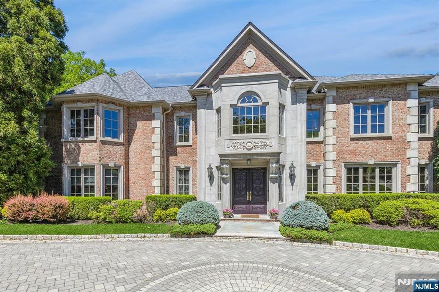 Nestled high atop the cliffs in prestigious Tammy Brook Hills, this custom built brick manor crafted with exquisite millwork and detail is designed by well known architect James Nigro. Stepping inside the grand marble foyer you're eye is immediately drawn to a magnificent 2 story formal living room with floor to ceiling windows and sweeping mountain /sunset view. The banquet sized dining room is an entertainer's dream. Grand chef kitchen expands to large eating area ,family room and outdoor terrace. Mahogany library/office, grand great room,2 ensuite bedrooms,2 powder rooms and laundry room complete the first floor. 2nd floor boasts impressive primary suite w/ tray ceilings sitting area & fireplace,2 ensuite bedrooms, 2 bedrooms with Jack & Jill bath. The walk out lower level is comprised of kitchen, gym, sauna, bedroom, full bath, theatre, rec room /game room which leads out to lush rear yard, patio & gleaming heated salt water pool. This residence is the pinnacle of elegant living.