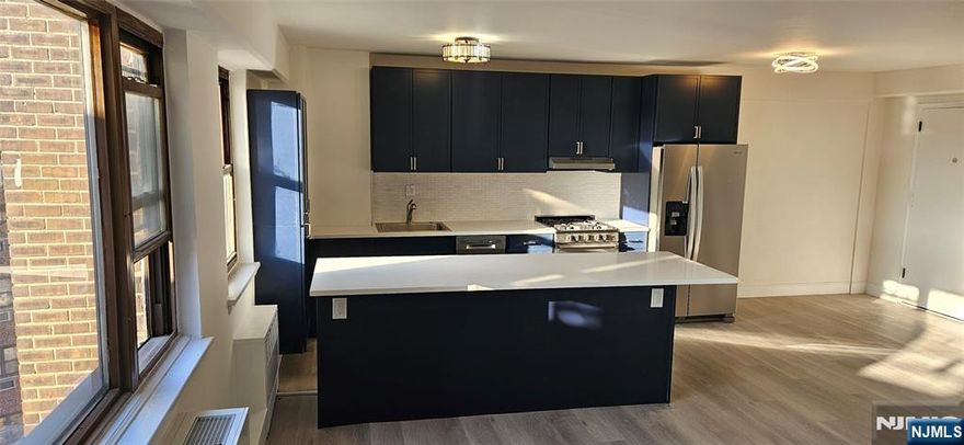 SUNSET VIEWS, GAS COOKING & INCLUDED PARKING: THE ULTIMATE STUDIO PLUS SANCTUARY. Experience a higher standard of living in this oversized, fully renovated 553 sq. ft. "Studio Plus." Perfectly situated directly across from the 167-acre Braddock Park, the Central Park of the Gold Coast, this residence is a rare gem. THE SPACE: A masterclass in open-concept design. This Natural Light haven features a seamless living, dining, and sleeping layout that feels surprisingly expansive. The updated kitchen is a chefâ€™s dream, featuring a generous island and a highly coveted GAS RANGE OVEN, a rare find for those who demand professional-level cooking. Complete with modern appliances, laminated wood floors, and a contemporary bathroom. THE "PLUS" FACTOR: Enjoy a multifunctional nook perfect for a home office, plus breathtaking sunset views over the parkâ€™s lakes from abundant windows. ALL-INCLUSIVE PEACE OF MIND: Your monthly fee includes ALL UTILITIES plus ONE ASSIGNED PARKING SPOT. Skip the winter parking stress and manage your budget with one simple payment. The building offers dual elevators, secure intercom entry, and a brand-new on-site laundry center. COMMUTER GOLD: NYC is minutes away. NJ Transit buses on BLVD East, ~0.5 miles to City Place shopping in Edgewater, and quick access to the Ferry and Lincoln Tunnel. THE STRATEGIC MOVE: Perfect for first-time buyers or 1031 Exchange investors.