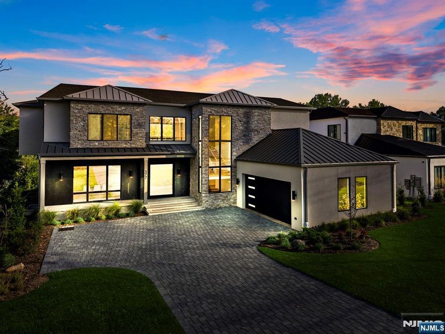 This Modern mansion is a collaboration between J Morra Management, tuaCASA design group and Zampolin Architects. This 6 bed, 6 full bath, 1 half bath, two car garage estate is situated on a 26,202 sq foot lot (0.6 acre) with the residence boasting 7,054 sq. feet of living area. The first floor starts with a grand oversized pivot door and continues to a foyer, gallery, two story great room with double sided fireplace, a chef's kitchen with commercial appliances and porcelain countertops, a separate prep kitchen and pantry with a second refrigerator and dishwasher, a breakfast area walking out to a covered patio, a library, mud hall and a guest en suite and powder room. The second floor features the primary suite with radiant heating in the master bath with 3 additional bedrooms - all en suite and walk in closets. The basement features a media room, guest room suite, gym and mechanical room. The fenced in backyard is curated for entertaining with a gunite pool and manicured lawns and a sprinkler system. Additional features include protection from whole house back up generator a central vacuum, porcelanosa vanities and tiles, wide plank white oak floors, and an additional outdoor patio surrounding the pool with 2x2 stone.