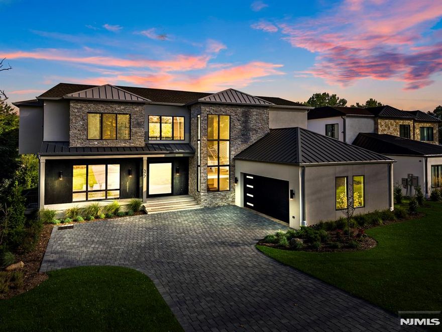 This Modern mansion is a collaboration between J Morra Management, tuaCASA design group and Zampolin Architects. This 6 bed, 6 full bath, 1 half bath, two car garage estate is situated on a 26,202 sq foot lot (0.6 acre) with the residence boasting 7,054 sq. feet of living area. The first floor starts with a grand oversized pivot door and continues to a foyer, gallery, two story great room with double sided fireplace, a chef's kitchen with commercial appliances and porcelain countertops, a separate prep kitchen and pantry with a second refrigerator and dishwasher, a breakfast area walking out to a covered patio, a library, mud hall and a guest en suite and powder room. The second floor features the primary suite with radiant heating in the master bath with 3 additional bedrooms - all en suite and walk in closets. The basement features a media room, guest room suite, gym and mechanical room. The fenced in backyard is curated for entertaining with a gunite pool and manicured lawns and a sprinkler system. Additional features include protection from whole house back up generator a central vacuum, porcelanosa vanities and tiles, wide plank white oak floors, and an additional outdoor patio surrounding the pool with 2x2 stone.