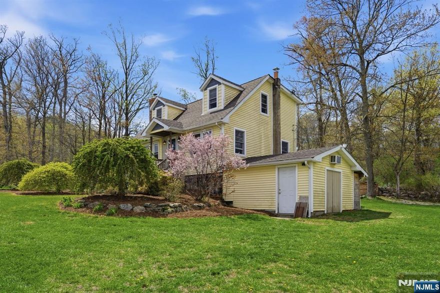 Perched high in Mahwah's sought-after Stag Hill, this 2-bedroom, 1.5-bath Cape offers a rare blend of privacy, space, and sweeping mountain views that feel nearly impossible to find in Bergen County. Set on a beautifully landscaped corner lot spanning over half an acre, 32 Pine Hill Rd feels like your own private retreat. Here, sunrises and sunsets aren't just something you catch once in a while-they become part of your daily routine. Morning coffee hits different, evenings feel quieter and after the rain, you're practically guaranteed a rainbow stretching across the mountains. Inside, the home offers warmth, charm, and functionality-perfect to enjoy as-is, with incredible potential to evolve over time. A newer 4-bedroom septic system (installed just 3 years ago) unlocks a rare opportunity for expansion, giving you the flexibility to grow the home into something even more substantial without the usual limitations. Outside, the expansive corner lot offers space to entertain, garden, or simply enjoy the peace and privacy that defines Stag Hill living. And then there's the number that truly sets this property apart: taxes under $4,500/year-almost unheard of in Bergen County. If you've been searching for land, views, low taxes, and long-term upside, this is more than a home-it's an opportunity you don't want to miss.