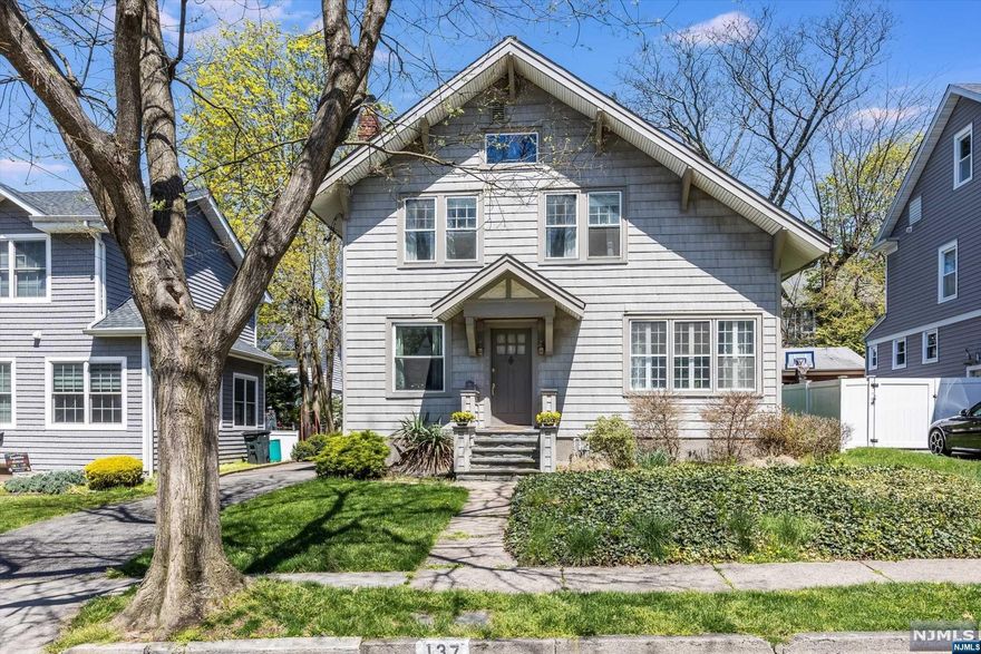 Welcome to this charming 3-bedroom, 2.5 bathroom Colonial in the adorable town of Leonia. This home has been lovingly cared for by the same family for over 80 years. Located on a quiet, tree-lined street just steps away from Overpeck Park, step inside to discover the beauty of this home's interior woodwork, inlayed floors, and light filled rooms. The living room features a gas fireplace flanked by built in cabinets with leaded glass doors. A separate sunroom/family room is the perfect spot to curl up with a book or binge your favorite TV show. The dining room showcases original wood paneling and a gorgeous coffered ceiling. The kitchen and a full first floor bath round out the first floor. Upstairs are 3 generous sized bedrooms as well as a bonus room perfect for office or play space, and another full bath. Outside is an oversized 2 car garage with loft storage and a well maintained yard and plantings. Enjoy nearby tennis courts, town pool, and Overpeck Park. Welcome Home