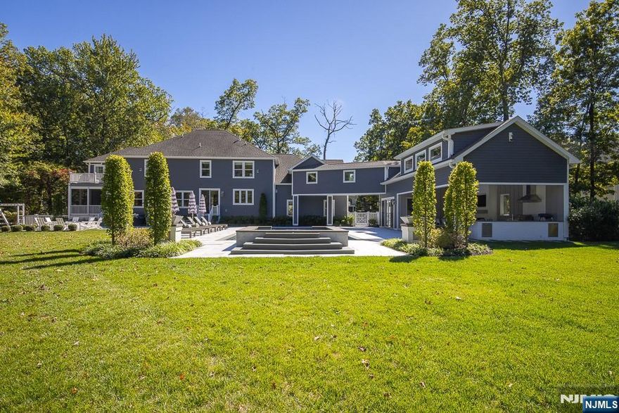 Welcome to this stunning luxury estate, offering a perfect blend of sophistication, comfort, and resort-style living. Private tours available with Rosemary at 845.304.3658. The gourmet kitchen, featuring a 64-inch refrigerator and freezer, double wall ovens, a built-in microwave, a farmhouse sink with filtered water, and a spacious wet bar with a wine fridge. Formal dining room, a living room with a cozy gas fireplace, and powder room. The office, set behind elegant French doors, features custom cabinetry. First-floor guest suite. Upstairs, the primary suite boasts a private deck, custom closets, and a luxurious en suite bathroom. Three additional bedrooms with Jack & Jill bath, guest room with en suite. The laundry room features double washers and dryers, the playroom/rec room is complete with built-in cabinetry and an electric fireplace. A unique second floor walkway bridge connects to the amazing pool house, radiant heat, bathroom, built-in speakers, gas fireplace, outdoor kitchen with a grill, pizza oven, bar area, refrigerator. Resort-style backyard oasis is truly breathtaking! A 20â€™ x 40â€™ gunite saltwater pool with a 10â€™ x 10â€™ elevated spa, waterfall, fire bowls, water shooters, fire pit, hot tub. Lower level rec room, a gym, storage. Oversized three-car garage, mudroom. This extraordinary property feels like a private resort, a true sanctuary youâ€™ll love coming home to. Minutes to major roadways to NYC, upstate NY, hiking trails, lakes, parks and equestrian c