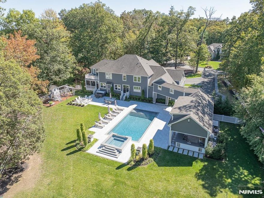 Welcome to this stunning luxury estate, offering a perfect blend of sophistication, comfort, and resort-style living. Private tours available with Rosemary at 845.304.3658. The gourmet kitchen, featuring a 64-inch refrigerator and freezer, double wall ovens, a built-in microwave, a farmhouse sink with filtered water, and a spacious wet bar with a wine fridge. Formal dining room, a living room with a cozy gas fireplace, and powder room. The office, set behind elegant French doors, features custom cabinetry. First-floor guest suite. Upstairs, the primary suite boasts a private deck, custom closets, and a luxurious en suite bathroom. Three additional bedrooms with Jack & Jill bath, guest room with en suite. The laundry room features double washers and dryers, the playroom/rec room is complete with built-in cabinetry and an electric fireplace. A unique second floor walkway bridge connects to the amazing pool house, radiant heat, bathroom, built-in speakers, gas fireplace, outdoor kitchen with a grill, pizza oven, bar area, refrigerator. Resort-style backyard oasis is truly breathtaking! A 20â€™ x 40â€™ gunite saltwater pool with a 10â€™ x 10â€™ elevated spa, waterfall, fire bowls, water shooters, fire pit, hot tub. Lower level rec room, a gym, storage. Oversized three-car garage, mudroom. This extraordinary property feels like a private resort, a true sanctuary youâ€™ll love coming home to. Minutes to major roadways to NYC, upstate NY, hiking trails, lakes, parks and equestrian c