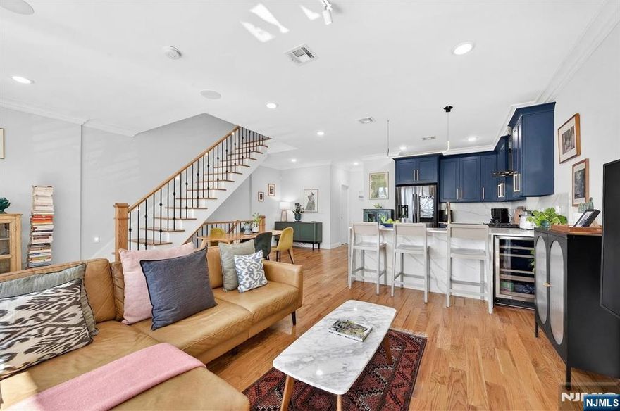 Welcome to this beautiful 3-bedroom, 2.5-bathroom condo in the heart of Jersey City Heights with a private roof deck and unobstructed views of Pershing Field Park and the NYC skyline. This bright and airy, east-facing home features an open layout with a sun-filled living area, floor-to-ceiling windows, and a Juliet balcony overlooking Pershing Field Park. The main level includes a powder room and a modern kitchen with stainless steel appliances and sleek cabinetry. Upstairs, the primary suite offers space for an office or den and an en-suite bathroom with porcelain tile, double vanity, and a lighted mirror. Two additional bedrooms and a full bathroom provide flexibility for guests, a home office, or other needs, with one bedroom offering access to a private balcony. A stacked washer/dryer is conveniently located in the hallway. The home also features a private 428 sq ft rooftop deck, ideal for outdoor entertaining or relaxing with NYC skyline views. Located one block from Central Avenue with quick access to local shops, restaurants, and everyday necessities. Conveniently near a bus stop with direct access to Port Authority in NYC as well as the Journal Square Path station.