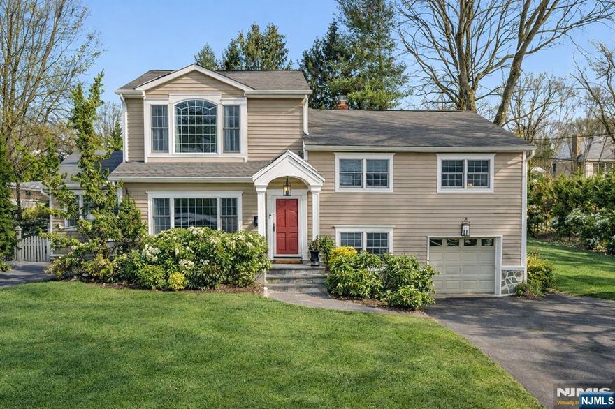 Set on a quiet, tree-lined street, this sprawling home offers sunlit interiors, hardwood floors, and a design that blends open sightlines with purposeful, well-defined rooms. The showstopper of this home is the massive great room that flows effortlessly into a stunning country kitchen, creating one expansive space ideal for gathering. The great room features vaulted ceilings, a gas fireplace, and oversized windows that frame the backyard. Just beyond, the kitchen blends custom cabinetry with soapstone and warm wood countertops, a Viking professional range set against a stone backsplash, pot filler and a generous center island with seating beneath statement pendants. A window-lined breakfast nook overlooks the deck, stone patio and expansive yard, bringing natural light into the heart of the home. The dining room is refined yet inviting with detailed millwork, an elegant fixture and French door that lead to the great room. Upstairs, the primary suite offers privacy with a vaulted ceiling, statement window, walk-in closet and an office nook. The en-suite bath includes rich custom cabinetry, dual vanity, and a glass-enclosed stone shower. Additional bedrooms are bright and well sized with hardwood floors and flexible use. The finished basement expands the home's versatility with dedicated space for recreation, workouts, and storage. Outside, the deck extends your living space into a deep, tree-lined backyard that feels private and peaceful throughout the year.