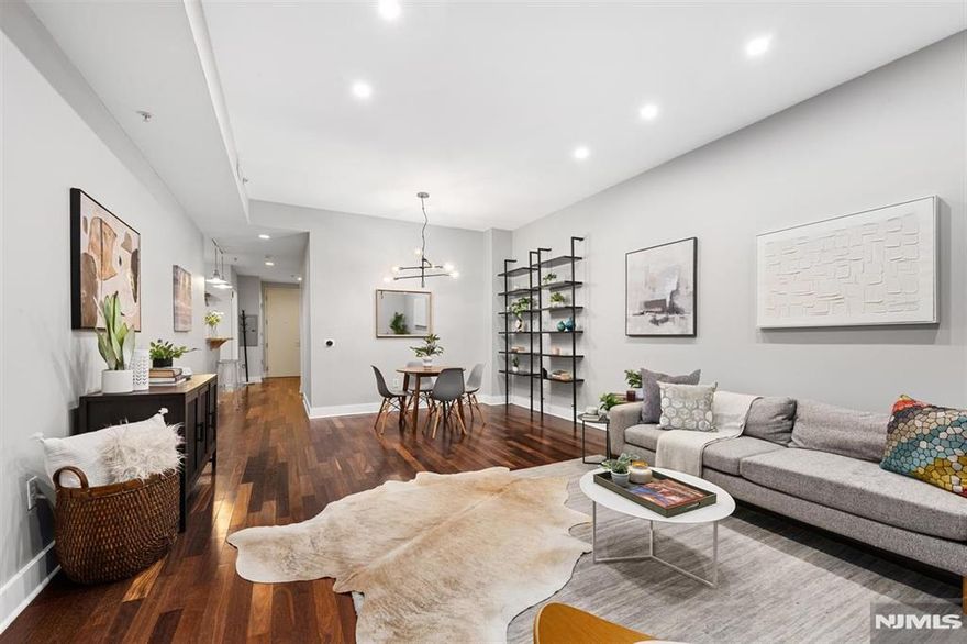 Welcome to Waldo Lofts, an award-winning boutique condominium in the coveted Powerhouse Arts District of Downtown Jersey City. This stylish 1-bedroom, 1-bath home offers approximately 829 sq ft of thoughtfully designed living space, blending modern finishes with a smart, open layout. Highlights include hardwood floors, soaring 10-foot ceilings, central A/C, recessed lighting, and an in-unit washer/dryer. The open living and dining area is framed by dramatic floor-to-ceiling windows, filling the home with natural light. The contemporary kitchen features stainless steel LG appliances, full-height maple cabinetry, granite countertops, mosaic tile backsplash, pendant lighting, and a breakfast bar ideal for entertaining. The spacious bedroom includes a walk-in closet for excellent storage. Residents enjoy premium amenities such as a fitness center, package room, bike storage, and secure key-fob access. The professionally managed building offers an on-site superintendent five days a week and cleaning services six days a week. Recent upgrades include a renovated lobby and advanced video intercom system. Monthly HOA fees cover hot water, gas, and Verizon Fios. Just moments from the Grove Street PATH, this home provides quick access to NYC and places you steps from Downtown Jersey Cityâ€™s vibrant dining, shopping, and cultural scene. Parking available nearby for an additional fee.