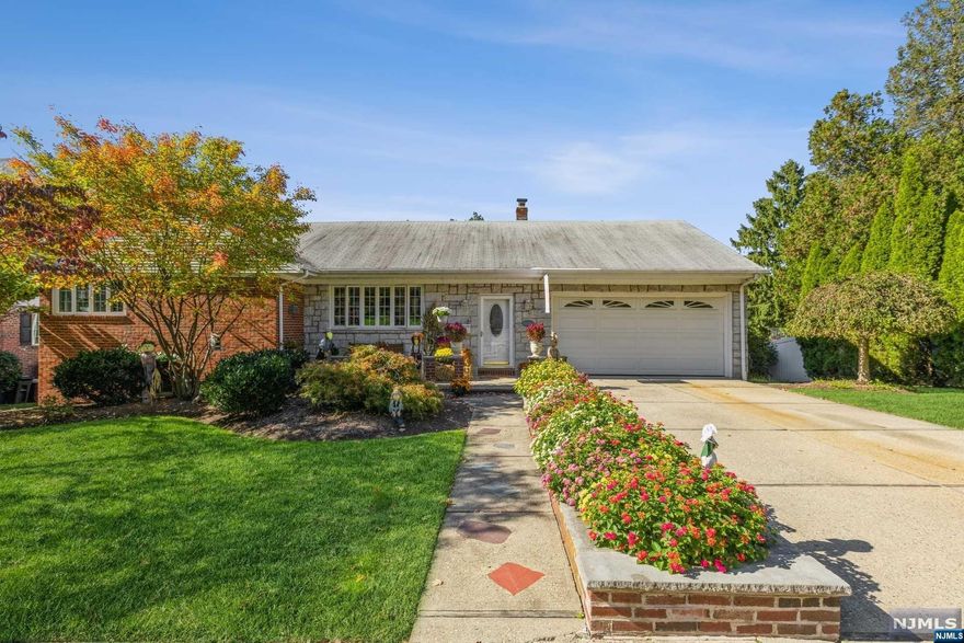 Showing pride in ownership, this meticulous Ranch is located on a beautiful tree lined street and has all you need! Stepping into the entry & up to the beautiful formal living room, you get that warm feeling. The Dining room has a large pass through into this stunning & new MEIK with sun-drenched windows & beautiful Sunsets. There's also a Deck off the kitchen with a Gas hookup for a BBQ. 3 Bedrooms and 2 Full Baths completes the first floor. Now the surprise.....proceeding towards hallway to the 2 Car Garage, storage and down steps to the ground level living space IS the Huge Recreation room with gas fireplace, Modern Eat-in Kitchen w/Center Island & Dining area. There's also an office, laundry area, beautiful full bath and storage. An outside exit to yard is very convenient for entertaining. The space is amazing for extended family or Guests! There are too many features to mention. 5 mins to Geo.Washington Bridge & all major Highways. Walk to schools, shopping & Transportation